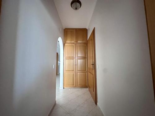 an empty hallway with a wooden door and a room at BayView Albufeira in Albufeira