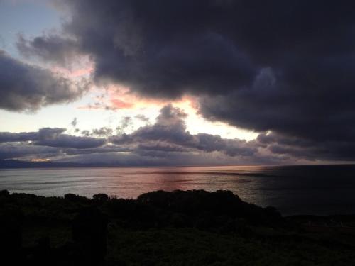 a stormy sky over the ocean with the sun setting at Adega Baia do Canto AL 1398 in Terra Alta