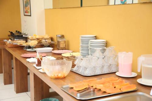 a table with cheese and plates and dishes on it at Hotel Belas Artes in Rio de Janeiro