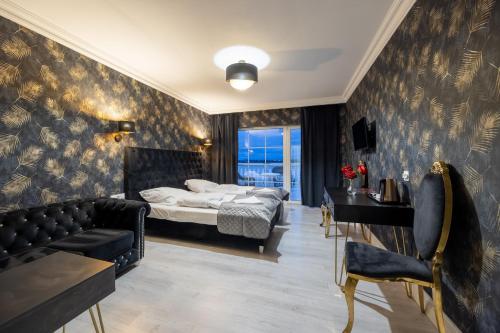 a bedroom with a bed and a couch at Dworek Kurowski in Szczecin