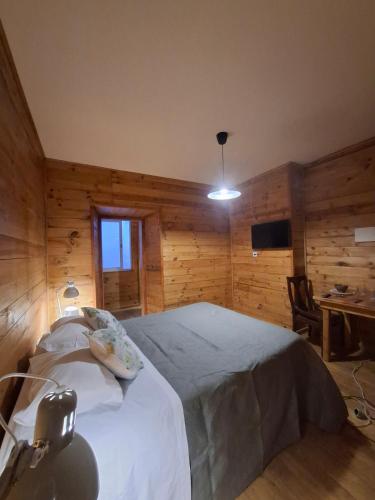 a bedroom with a bed in a room with wooden walls at Setubal Apartments in Setúbal