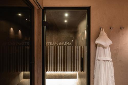 a dress hanging in a glass door of a store at Bergmähder - Alpine Residence in Oberlech