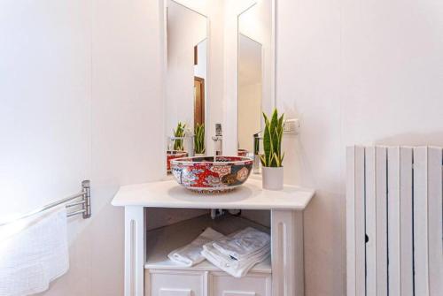 a bathroom with a white vanity with a mirror at Artist's Suites in Spoleto