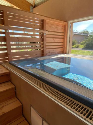 a jacuzzi tub in a house with a window at Résidence de Nodeven in Guissény