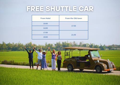 a group of people standing next to a golf cart at Athenia Hoi An Boutique Hotel & Spa in Hoi An