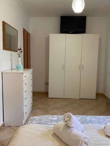 a bedroom with white cabinets and a bed with a towel at Vivienda 2 dormitorios Churriana-Aeropuerto in Málaga