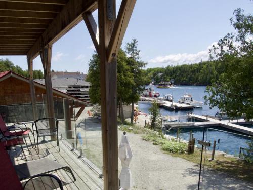 a porch with a view of a marina with boats in the water at Big Tub Resort & Marina in Tobermory