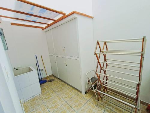 a garage with a door and a tiled floor at Espectacular Casa de Playa en Asia frente al Mar in Asia