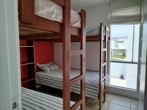 a room with two bunk beds and a window at Espectacular Casa de Playa en Asia frente al Mar in Asia
