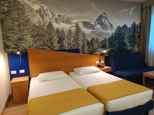 Ένα ή περισσότερα κρεβάτια σε δωμάτιο στο Hotel Express Aosta East
