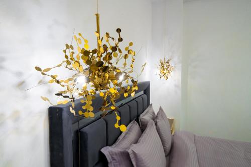 a chandelier with yellow flowers on top of a bed at Galactic&Ludmila Suite SPA in Braşov