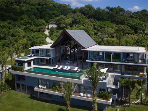 an aerial view of a house with a swimming pool at Villa Saan - SHA Extra Plus in Kamala Beach