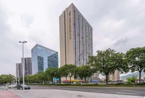 a large tall building in a city with trees at 翠畔loft公寓 in Guangzhou