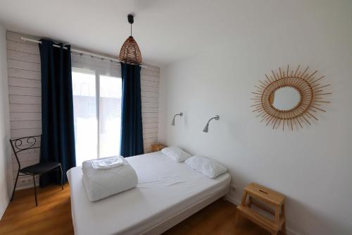 a bedroom with a bed with a mirror on the wall at Résidence de Nodeven in Guissény