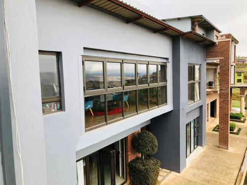 an external view of a white building with windows at At TheSoil in Edendale