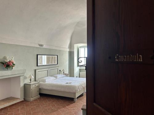 a bedroom with a bed and a fireplace at Palazzo Contelori in Terni