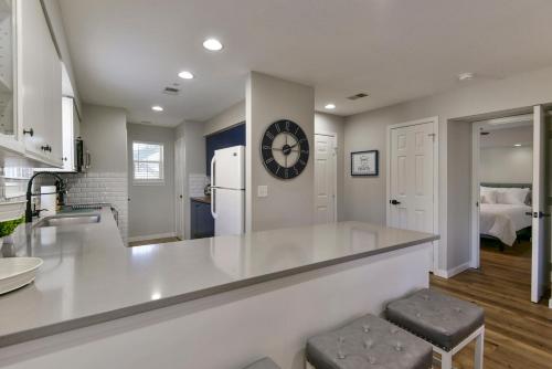 a kitchen with a counter and a clock on the wall at Luxurious Condo at Holiday Hills Resort - Beautifully Updated and Affordable - Family Amenities - No Steps in Branson