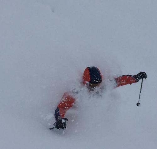 a person is skiing down a snow covered slope at Kogakuro in Myoko