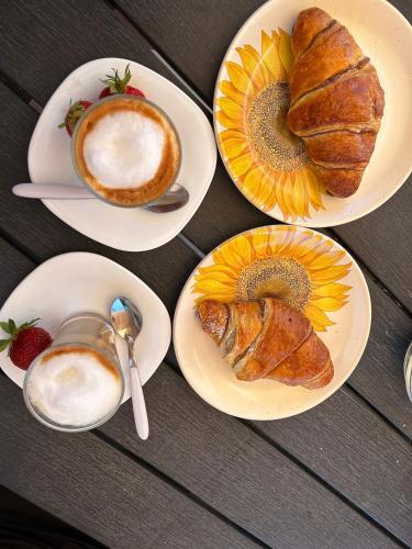 a table with plates of pastries and a cup of coffee at Agriturismo da Michele e Carmela di Voli Patrizia in Donoratico