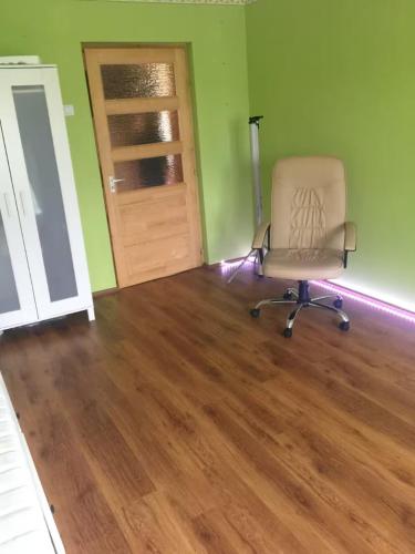 an empty room with a chair and a door at Sleeps 7 - FamilyFriendly - CloseToLakeBalaton in Mátyásdomb
