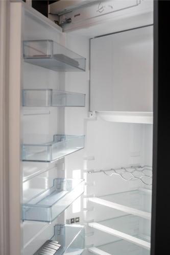 an empty refrigerator with glass shelves in it at Gorska Vila in Kopaonik