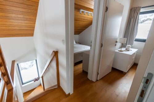 a small attic room with a bed and a mirror at Gorska Vila in Kopaonik
