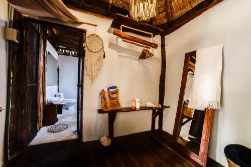 a room with a mirror and a table and a mirror at Eco Bañitas Tulum in Tulum