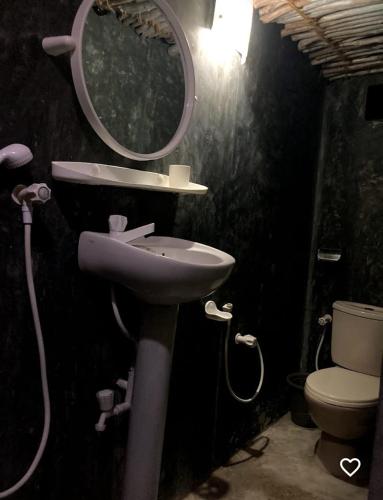 a bathroom with a sink and a mirror and a toilet at Dolce Vita Villa Ahangama in Ahangama