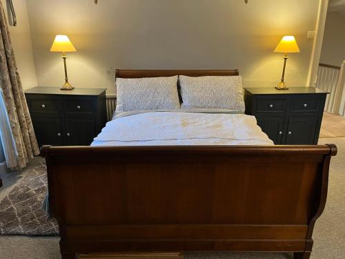 a bedroom with a large bed with two lamps on both sides at Humphreston House in Bristol