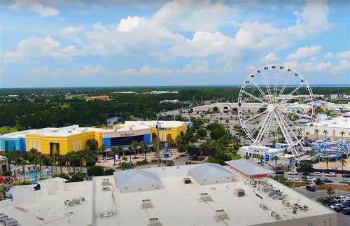 an aerial view of a amusement park with a ferris wheel at Sandcastle on Castile in Panama City Beach