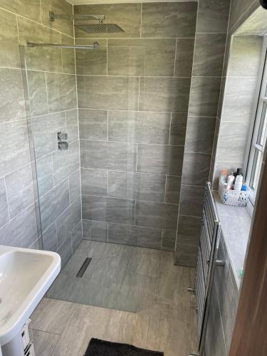 a bathroom with a shower and a sink at Executive, 3-storey town house in Runcorn