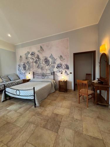 a bedroom with a bed and a painting of flowers on the wall at B&B Il Papavero in Tuscania
