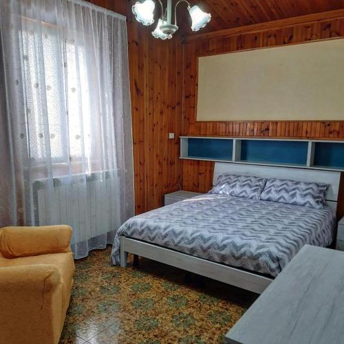 a bedroom with a bed and a table and a chair at Casa Vacanze Domus Angela in Barrea