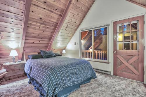a bedroom with a bed and a wooden wall at Cholula Chalet 811C in South Lake Tahoe