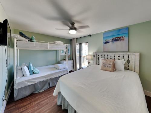 a bedroom with two bunk beds and a ceiling fan at Solana Shores #2 in Perdido Key