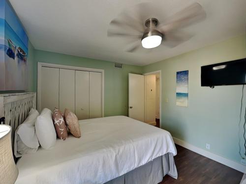 a bedroom with a bed with a ceiling fan at Solana Shores #2 in Perdido Key