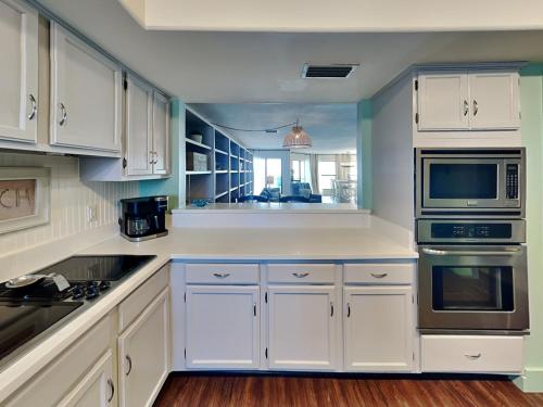 a white kitchen with white cabinets and appliances at Solana Shores #2 in Perdido Key
