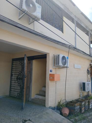 an entrance to a house with a door and a balcony at résidence IDIMAH in Sada