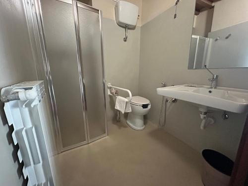 a bathroom with a shower and a toilet and a sink at Palazzo Contelori in Terni