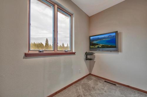 a room with two windows and a flat screen tv at 1044C Coyote Ridge in South Lake Tahoe