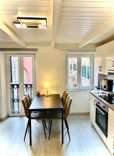 a kitchen with a dining room table and chairs at Helena Old Town Corfu 3 in Corfu