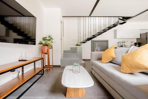 a living room with a couch and a table at RB109 - 2BR - 2BTh in Cuernavaca