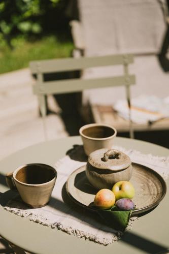 a plate of food on a table with bowls and apples at Casa Kiko Pecetto in Pecetto