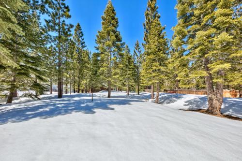 a road covered in snow with trees in the background at Tall Pines in South Lake Tahoe