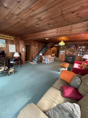 a large living room with a couch and a staircase at SUNSET HAVEN LIMIT 8 cottage in Gray
