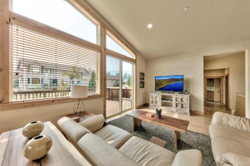 a living room with a white couch and a large window at 1376MD Angora View in South Lake Tahoe