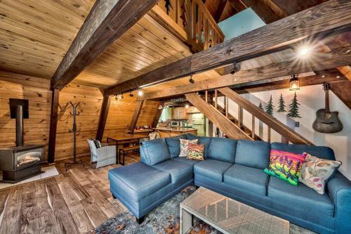 a living room with a blue couch and a stove at 3001R Reindeer A Frame Cabin in South Lake Tahoe