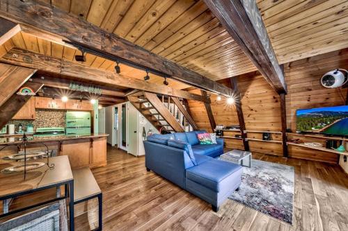 a living room with a blue couch in a room with wooden ceilings at 3001R Reindeer A Frame Cabin in South Lake Tahoe
