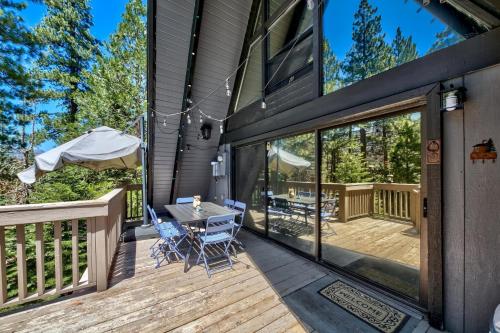 a patio with a table and chairs on a deck at 3001R Reindeer A Frame Cabin in South Lake Tahoe