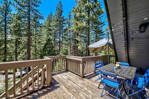 a patio with a table and chairs on a deck at 3001R Reindeer A Frame Cabin in South Lake Tahoe